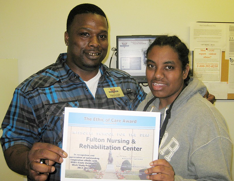 Marcus Ivory, dietary manager of Fulton Nursing and Rehab in Fulton, receives a certificate of Recognition and Appreciation from Benza Kasse, a senior at the Missouri School for the Deaf who participated in this year's Work-Study Program at MSD.