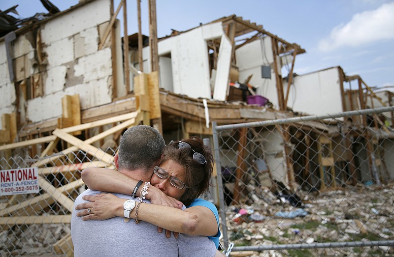 Shona Jupe, a resident of the apartment building destroyed by fertilizer plant explosion, hugs her friend Friday as they met while she was visiting the site in West, Texas. Jupe was at the front door when the West Fertilizer Co. explosion happened. Texas law enforcement officials on Friday launched a criminal investigation into the massive fertilizer plant explosion that killed 14 people last month, after weeks of largely treating the blast as an industrial accident.