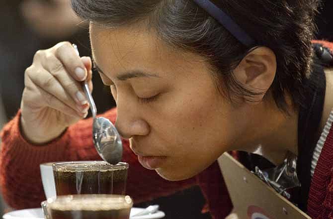 In this Thursday, April 13, 2013 photo, one of the judges tests the aroma of a brewed entry at the annual United States Barista Championship in Boston.