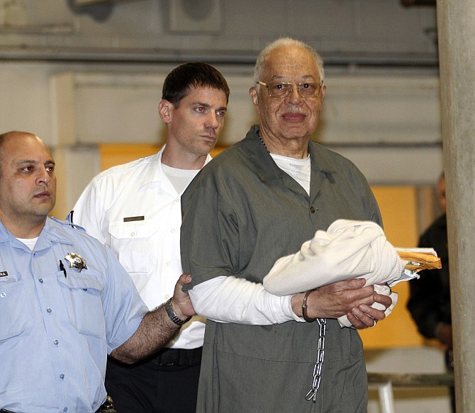 Dr. Kermit Gosnell is escorted to a waiting police van upon leaving the Criminal Justice Center in Philadelphia Monday after being convicted of first-degree murder in the deaths of three babies who were delivered alive and then killed with scissors at his clinic. 
