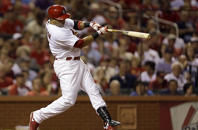 Carlos Beltran of the Cardinals follows through on a three-run home run during the fifth inning of Tuesday's game with the Mets in St. Louis.