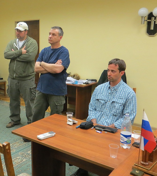 A man claimed by FSB to be Ryan Fogle, right, a third secretary at the U.S. Embassy in Moscow, sits among Embassy officials at left, sits in the the FSB offices in Moscow, easrly Tuesday. Russia's security services say they have caught a U.S. diplomat who they claim is a CIA agent in a red-handed attempt to recruit a Russian agent.