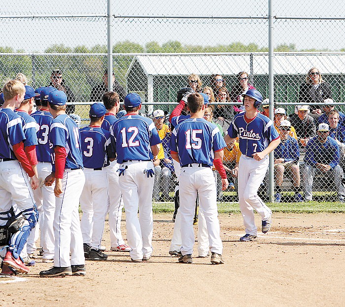 After crossing homeplate, California's JT Trachsel (7), at right, is congratulated on his homerun by teammates Saturday at the Class 3 District 8 Tourney at North Callaway.