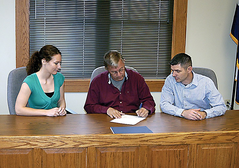 A Proclamation is signed by California Mayor Norris Gerhart Monday, May 6, designating May 5-11 Children's Mental Health Week. From left are, Burrell Caseworker Danielle Taylor, Gerhart and Burrell Clinic Manager Guy Van Drunen
