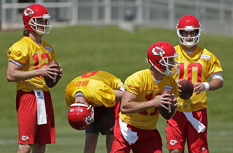 Chiefs quarterbacks (from left) Ricky Stanzi, Tyler Bray, Alex Smith and Chase Daniel participate in a drill during camp Wednesday in Kansas City.