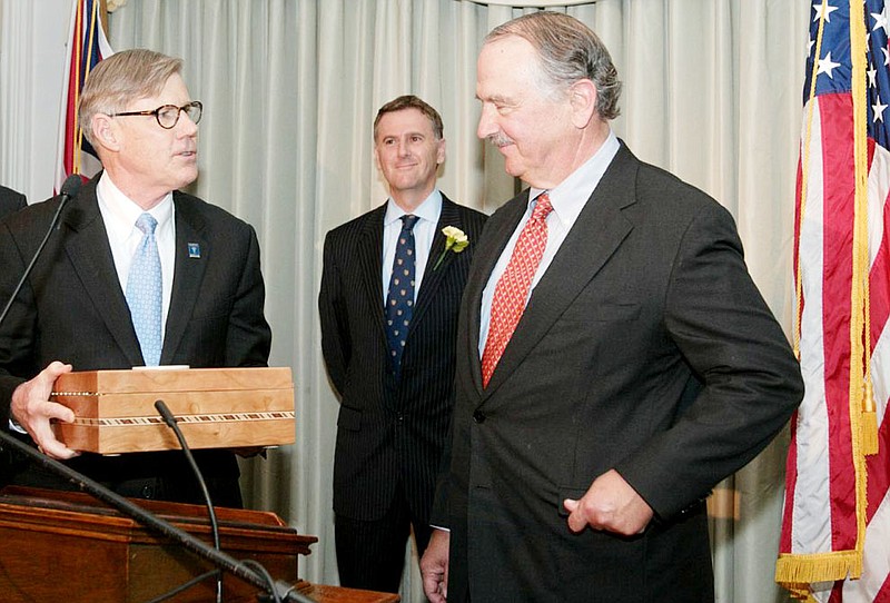 Westminster College President George B. Forsythe, left, presents the Winston Churchill Medal for Leadership and a humidor to former U.S. Ambassador to Belgium Stephen F. Bauer of St. Louis. in the background is Dr. Rob Havers, executive director of the Nationial Churchill Museum in Fulton.