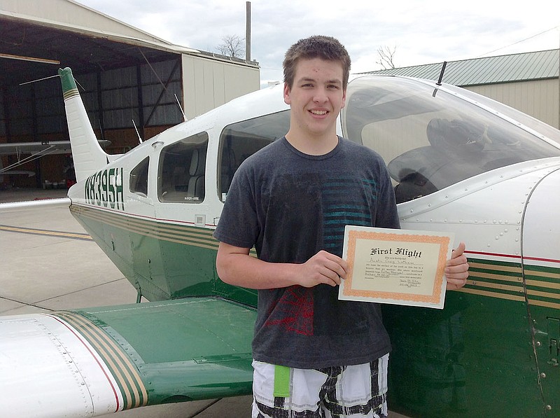 Austin Latham, one of the 2012 recipients of the Kingdom Pilots Association's Sam Robertson Scholarship, displays his certificate after his first solo flight on May 6. The formal presentation of the 2013 Sam Robertson Scholarship recipients will take place at 9 a.m. Saturday during the KPA's annual fly-in pancake breakfast fundraiser at the airport.