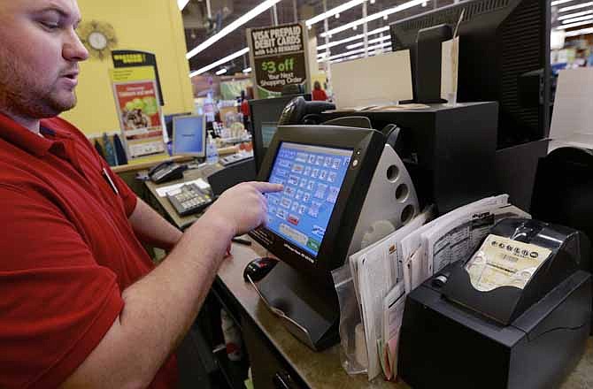 Parker Adair works the Powerball machine at a Baker's supermarket in Omaha, Neb., Wednesday, May 15, 2013. After weeks of rolling without a winner, the Powerball jackpot ballooned in time for its Wednesday drawing, an estimated $360 million jackpot. However, no one won the third largest Powerball jackpot and the seventh largest jackpot in history, triggering a larger jackpot for Saturday's drawing.