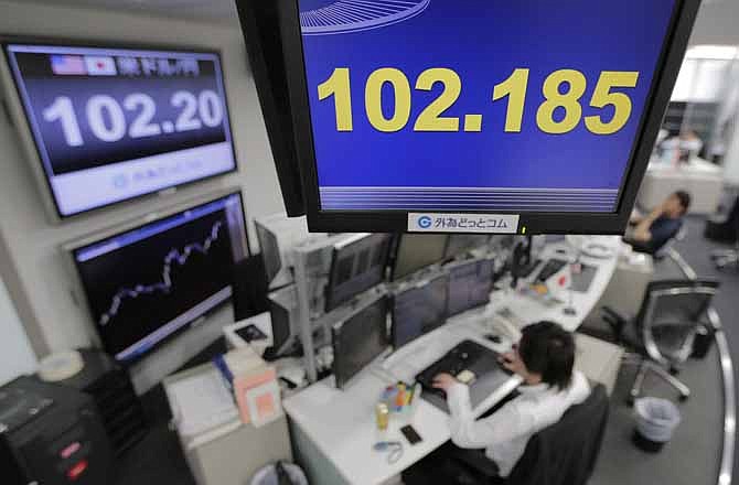 Money traders work under screens indicating the U.S. dollar rate against the Japanese yen at a foreign exchange company in Tokyo, Wednesday, May 15, 2013. The dollar was trading 102 yen level as enthusiasm on Wall Street sparked by another positive report on the U.S. economy helped push most Asian stock markets higher Wednesday. 