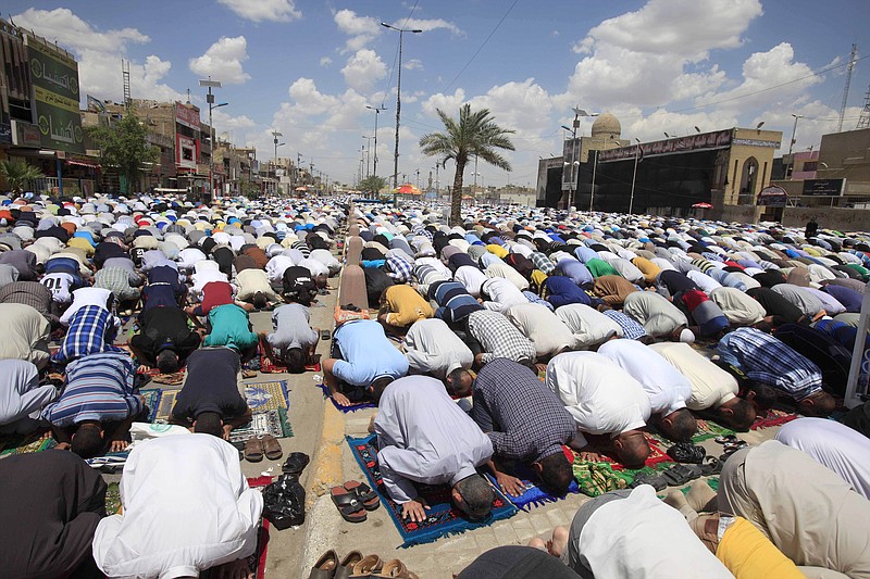 Followers of Shiite cleric Muqtada al-Sadr pray during Friday prayers in the Shiite stronghold of Sadr City in Baghdad, Iraq. Elsewhere, a bomb killed dozens of people at a Sunni mosque in central Iraq. The attack in Baqouba comes after two days of attacks and left tens of people dead.