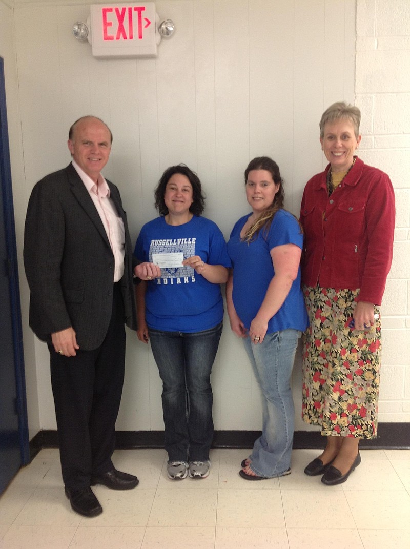 The Russellville PTO donated more than $4,000 to support the building security upgrades at Cole County R-I Schools. Superintendent Jerry Hobbs, left, and Elementary Principal Karen Ponder, right, accepted the check from PTO officers Maggie Schrader and Lindsey Stinson. Submitted photo