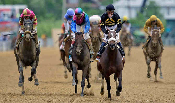 Jockey Gary Stevens celebrates aboard Oxbow after winning the 138th Preakness Stakes horse race at Pimlico Race Course, Saturday, May 18, 2013, in Baltimore. Itsmyluckyday, third from left, ridden by John Velazquez, finished second; and Mylute, left, ridden by Rosie Napravnik finished third.