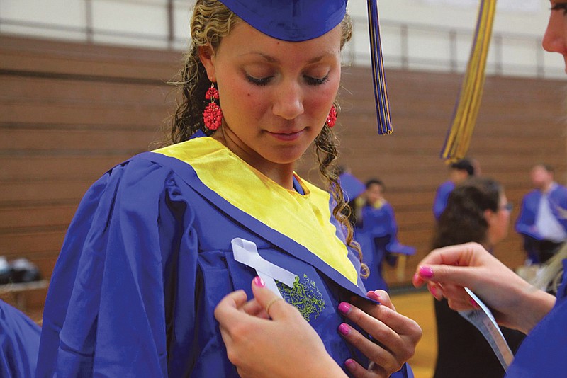 Graduate Jill Maier, in honor of fallen student Andrea Rebello, wears a ribbon on her gown during the commencement ceremony at Hofstra University.