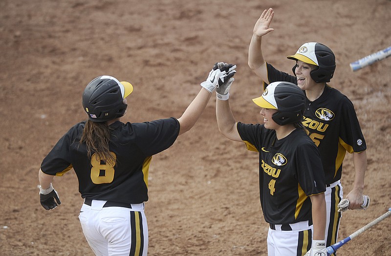 Nicole Hudson high-fives a pair of Missouri teammates after hitting a two-run home run in the bottom of the fifth inning of Sunday's second game against Hofstra in the NCAA Regionals in Columbia.