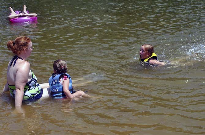 A family relaxes at Public Beach 2 in Lake of the Ozarks State Park.