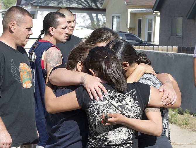 Residents react to an incident Sunday afternoon at on Pueblo's East Side after a man believed to be a predator was apprehended by some other residents and later taken into custody by police.
