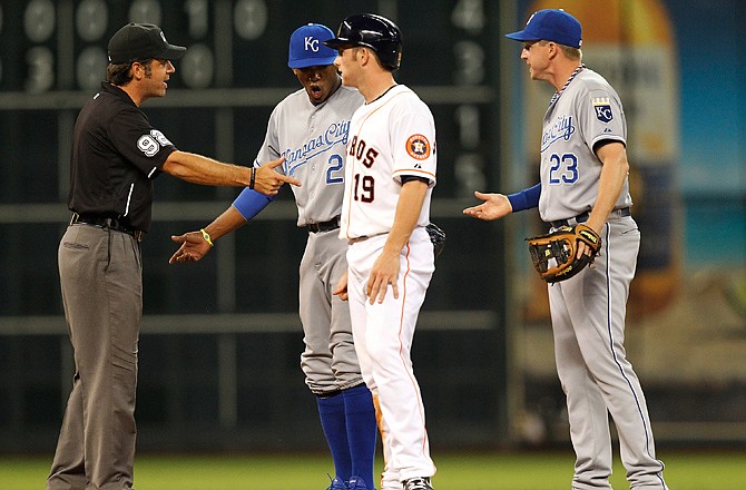 Royals shortstop Alcides Escobar and second baseman Elliot Johnson argue with second base umpire James Hoye after he ruled Escobar missed second base as he attempted to turn a double play on Robbie Grossman of the Astros during Monday night's game in Houston.