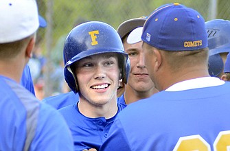 Nolan Bax of Fatima is surrounded and congratulated by teammates and coaches after hitting a grand slam in the top of the seventh inning in Tuesday's Class 3 sectional against Holden in Westphalia.