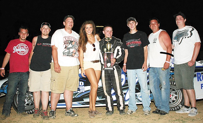 At center is Derek Henson, Russellville, celebrating his feature win in the Street Stock Division with pit crew members including brother Cole Henson, at Derek's right, and friends Sunday night at the Double-X Speedway.