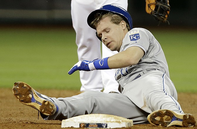Chris Getz of the Royals tries to sit up as Jose Altuve of the Astros signals the out during the eighth inning Wednesday night in Houston.