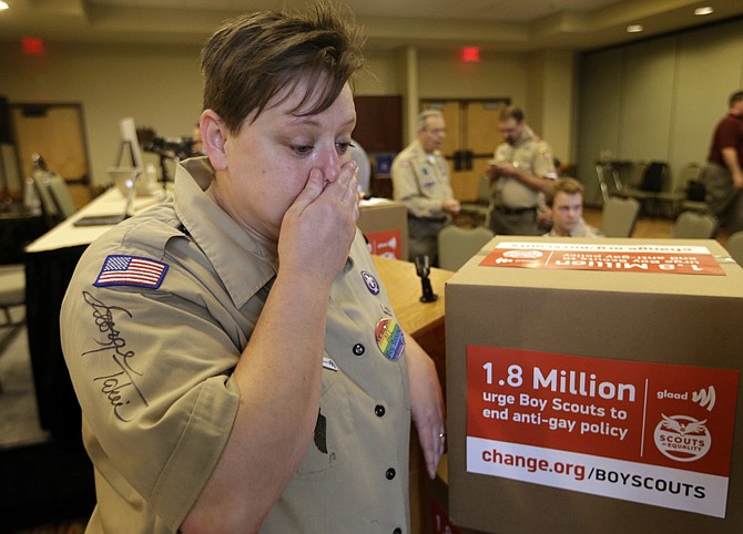 Former Cub Scouts den leader Jennifer Tyrrell, who was ousted from Scouting because she is openly gay, becomes emotional as she responds to a reporter's question Thursday in Grapevine, Texas. Local leaders of the Boy Scouts of America voted Thursday to ease a divisive ban and allow openly gay boys to be accepted into the nation's leading youth organization - one of the most dramatic moves the organization has made in a century.