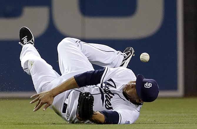 San Diego Padres right fielder Kyle Blanks drops a catch off a hit for a single by St. Louis Cardinals' Yadier Molina during the eighth inning of their baseball game Wednesday, May 22, 2013, in San Diego.