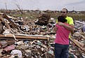 Ryan Steele hugs his girlfriend, Lauren Troxell, on Thursday in what is left of the home he shared with his parents after it was destroyed by a tornado in Moore, Okla.
