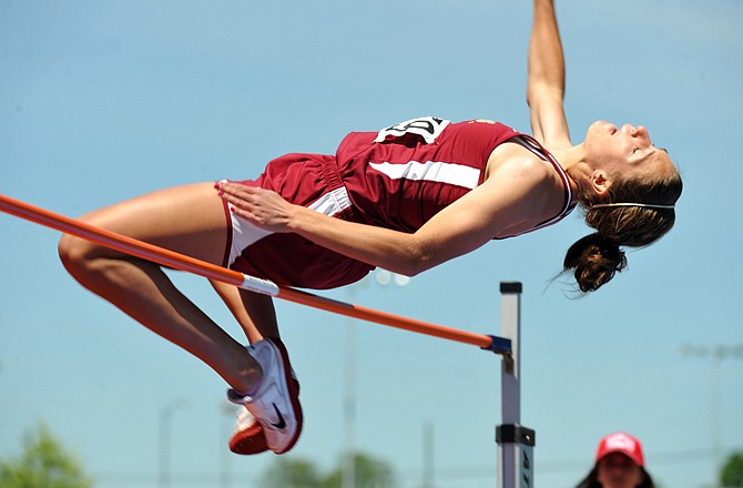 Eldon's Sara Rhine clears the bar during Friday's high jump at the Class 3 state track and field meet at Dwight T. Reed Stadium. Rhine won her second straight state title in the event.