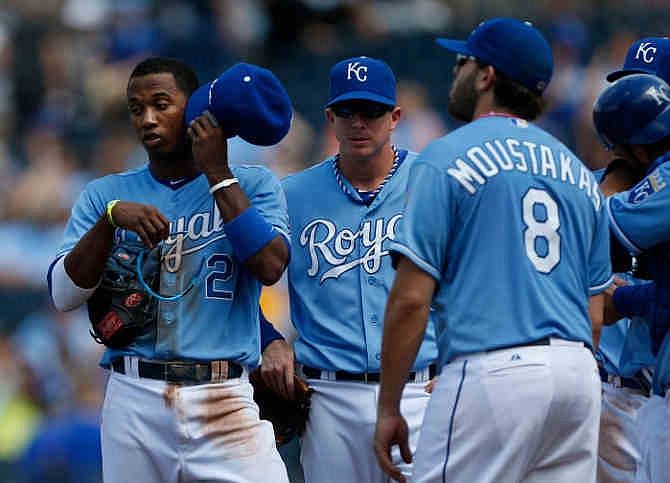 Kansas City Royals shortstop Alcides Escobar (2), second baseman Chris Getz and third baseman Mike Moustakas (8) wait during a pitching change in the eighth inning of the MLB American League baseball game against the Los Angeles Angels at Kauffman Stadium in Kansas City, Mo., Saturday, May 25, 2013. 