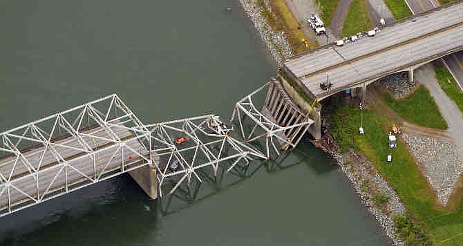 A collapsed section of the Interstate 5 bridge over the Skagit River is seen in an aerial view Friday, May 24, 2013. Part of the bridge collapsed Thursday evening, sending cars and people into the water when a an oversized truck hit the span, the Washington State Patrol chief said. Three people were rescued from the water.