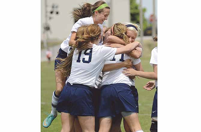 Helias players jump for joy in celebration of Tiffany Weaver's (back right) first goal of their game against Carl Junction on Saturday in Jefferson City.