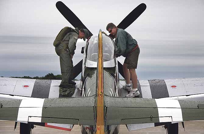 Colonel Larry Lumpkin of the Commemorative Air Force, left, prepares to take off in a North American Aviation P-51 Mustang known as "Gunfighter" at the 25th Anniversary 2013 Salute To Veterans Air Show held at the Columbia Regional Airport on Saturday, May 25, 2013.