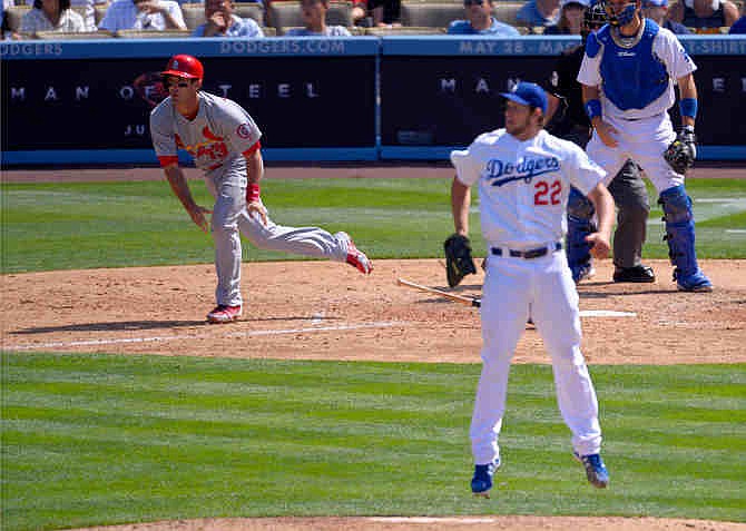St. Louis Cardinals' Matt Carpenter, left, hits an RBI-single as Los Angeles Dodgers starting pitcher Clayton Kershaw (22) jumps and catcher A.J. Ellis looks on during the seventh inning of a baseball game on Sunday, May 26, 2013, in Los Angeles.