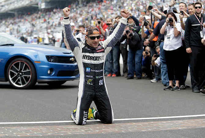 Tony Kanaan, of Brazil, celebrates on the start/finish line after winning the Indianapolis 500 auto race at the Indianapolis Motor Speedway in Indianapolis, Sunday, May 26, 2013. 