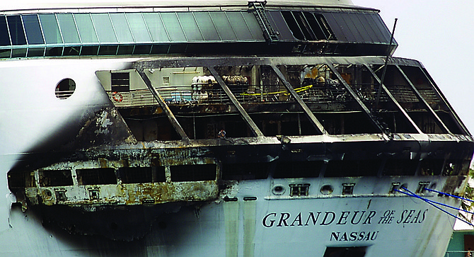 The fire-damaged exterior of Royal Caribbean's Grandeur of the Seas cruise ship is seen while docked in Freeport, Grand Bahama island. 