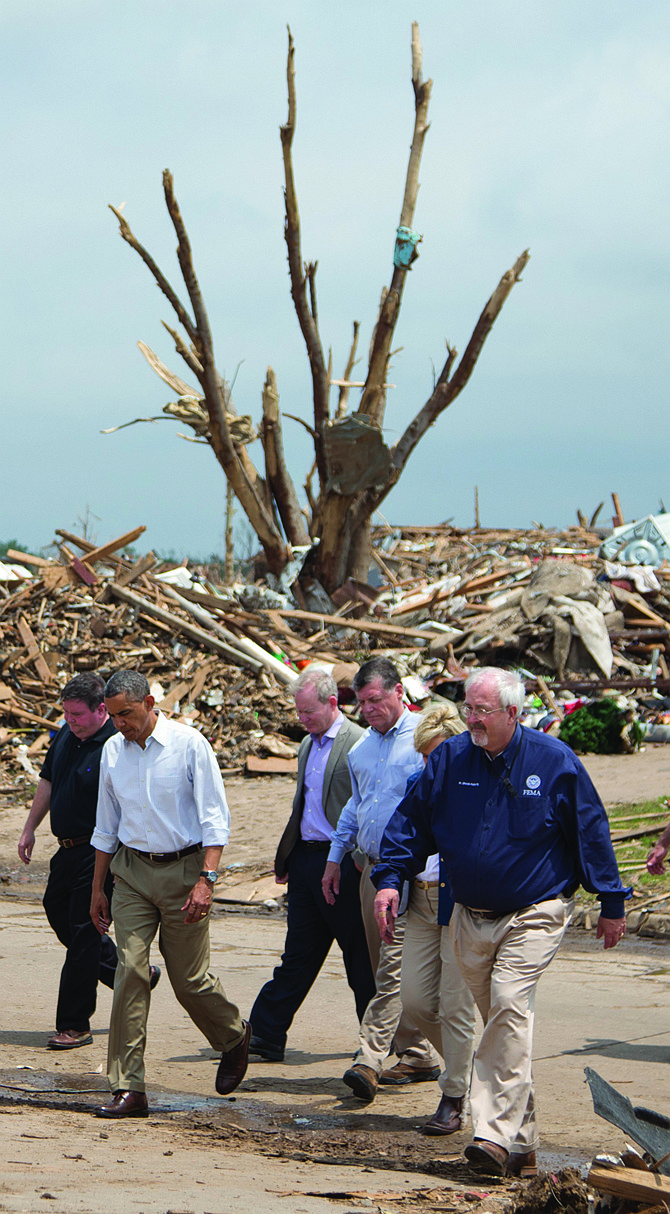 President Barack Obama tours the devastated Plaza Towers Elementary School and the surrounding area with Moore, Okla., Mayor Glenn Lewis, left, and Oklahoma Gov. Mary Fallin, second from right, and FEMA administrator W. Craig Fugate, right. 
