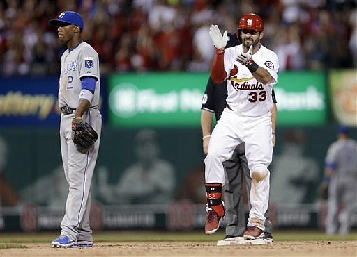 Daniel Descalso of the Cardinals applauds as he stands on second near Royals shortstop Alcides Escobar after hitting a two-run single during the eighth inning of Wednesday night's game at Busch Stadium. Descalso advanced to second on the throw home.