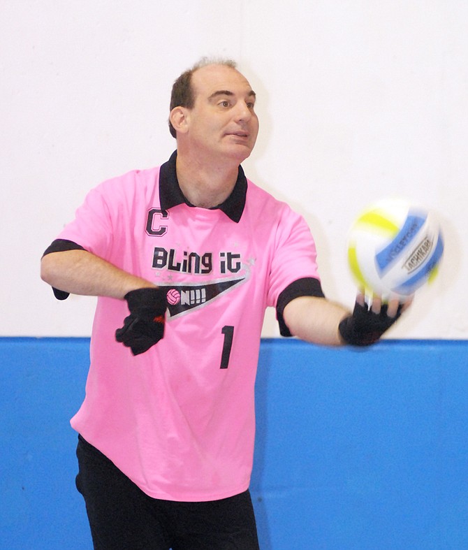 Team captain Travis Mankin serves the ball at volleyball practice in Shikles Gymnasium during his team's last practice before the state finals at the Special Olympics on Friday.