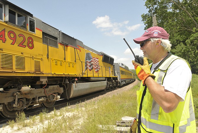 Union Pacific Railroad conductor Bob Burke directs his engineer when to stop during a brief ride Thursday afternoon. Burke was part of a crew that that worked the ride designed to highlight rail crossing safety.