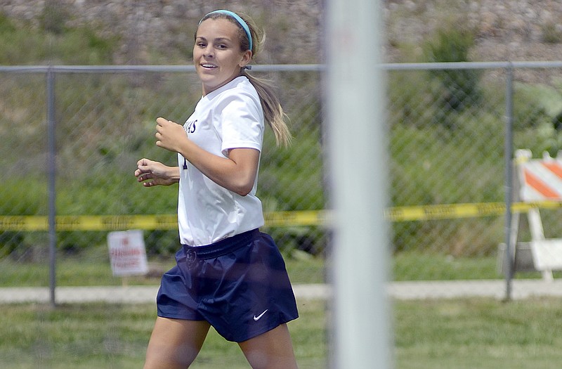Sydnee Kliethermes of Helias is all smiles as she watches her shot roll into the net against Carl Junction during Saturday's quarterfinal game at the 179 Soccer Park.