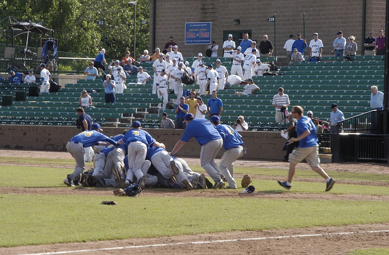 The Fatima Comets pile on the mound Friday afternoon after defeating the Springfield Catholic Fighting Irish 2-0 to capture the Class 3 state title in O'Fallon.