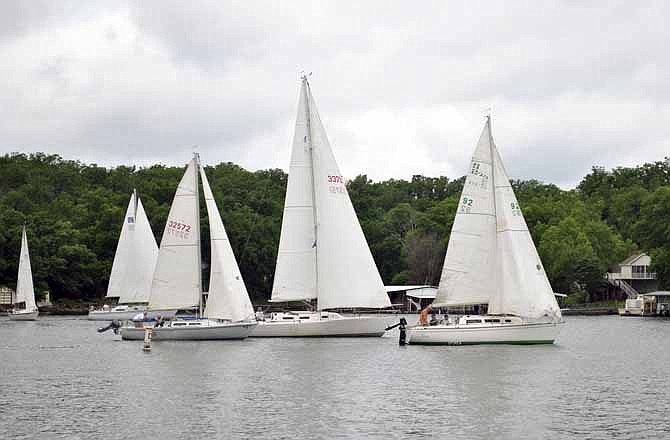 Sailboat competitors in the OYC Kids' Harbor Cup Charity Regatta start the event's first race heading toward the first buoy marker Saturday in Lake Ozark, Mo.