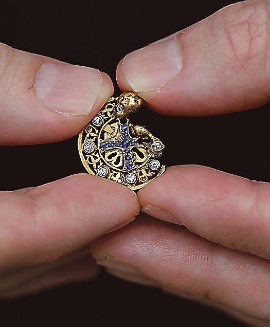 Mark Rubinstein holds a gold pendant that he found the pendant during Florida's official Burmese python hunt last winter. 