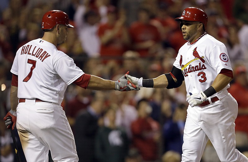 Carlos Beltran is congratulated by Cardinals teammate Matt Holliday after hitting a two-run home run during the sixth inning of Monday night's game against the Diamondbacks at Busch Stadium.