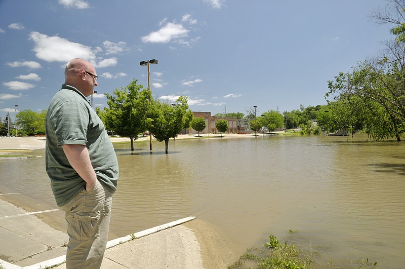 On his lunch break, Tony Wilde checks out the waters from Wears Creek on the state parking lot by West Main Street.