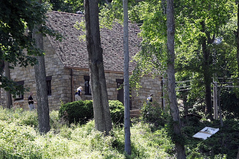 Investigators examine the classroom/administration building Monday after an explosion at Nyack College in Nyack, N. Y. Natural gas had risen to "explosive" levels in the manholes at the college where a blast rocked a building Tuesday, injuring seven people, officials said.