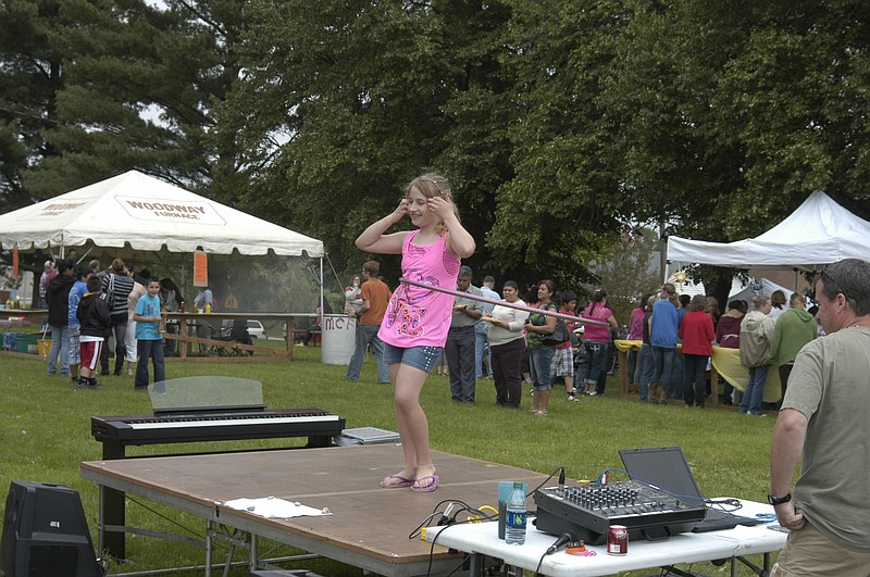 Democrat photo / David A. Wilson
Colby Arnold puts her abilities with the hulahoop to good use on the talent stage at the Annunciation Catholic Picnic on Sunday, June 2.