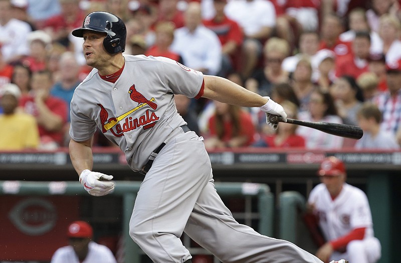 The Cardinals' Matt Holliday follows through on his swing during Friday's game against the Reds in Cincinnati.