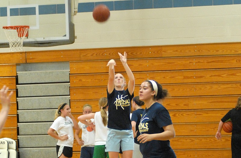 A pair of Helias girls basketball players run through drills during camp earlier this week at Rackers Fieldhouse.