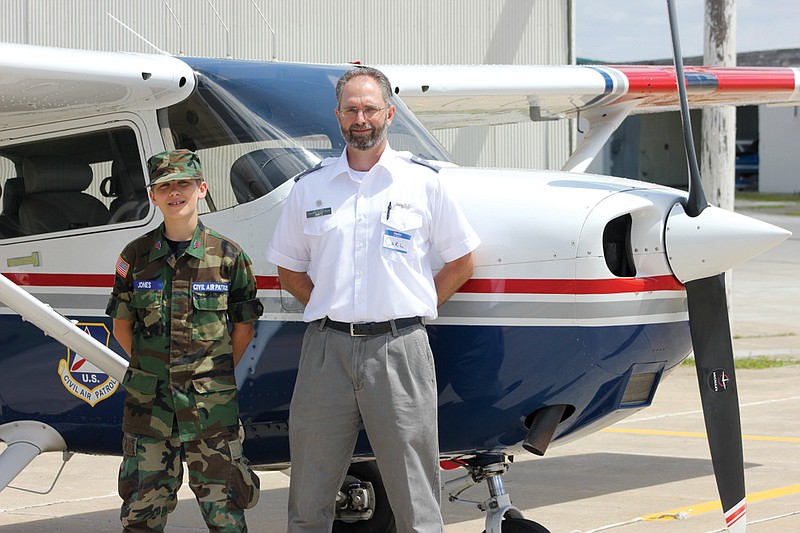 Carl Jantz of the Central Missouri Composite Squadron of the Civil Air Patrol poses with Alexander Jones, 13, of Millersburg at the Fulton Airport on Saturday during an open house event. The Civil Air Patrol is seeking adult volunteers to support the Cadet Program and other programs and services in the central Missouri area.